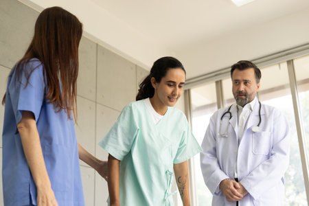 Doctor and physiotherapist doing a rehabilitation recovery for Hispanic patient girl. Healthcare and medical service at the hospital. The medical exam and therapy for body pain injury.の写真素材