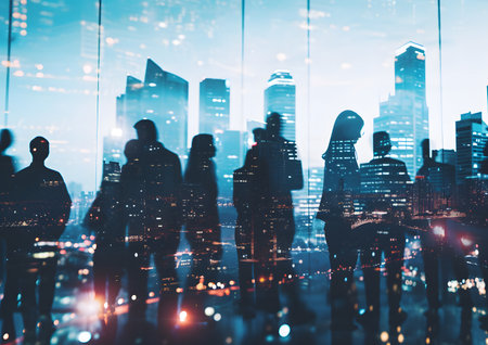 Silhouette of business people work together in the office. Double exposure with highrise modern city office building concepts. Success ,agreement ,teamwork and partnership.の素材