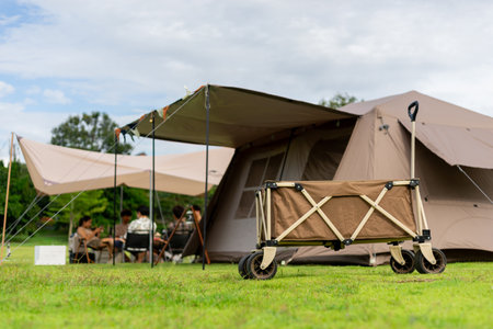Camping picnic green tent campground in outdoor park lake. Camper while campsite in mountain and lake nature background at summer trip camp. Adventure Travel and Vacation conceptの写真素材