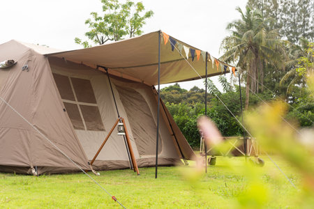 Camping picnic green tent campground in outdoor park lake. Camper while campsite in mountain and lake nature background at summer trip camp. Adventure Travel and Vacation conceptの写真素材