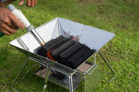 Food lover at Camping! Cooking food during camping at natural lake and mountain view background. Recreation and journey outdoor activity lifestyle.の写真素材