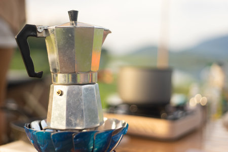Food lover at Camping! Dripping coffee during camping at natural lake and mountain view background. Recreation and journey outdoor activity lifestyle.の写真素材