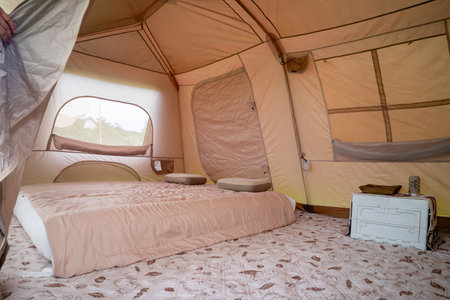 Camping picnic green tent campground in outdoor park lake. Camper while campsite in mountain and lake nature background at summer trip camp. Adventure Travel and Vacation conceptの写真素材