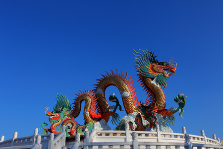 Chinese style golden dragon statue,with blue sky in beautiful daylight.の写真素材