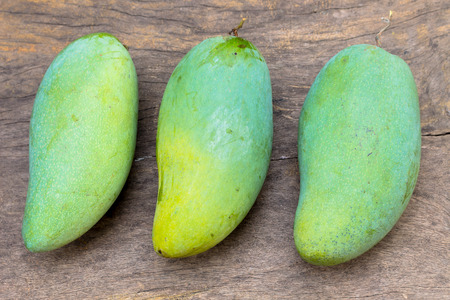 three ok-rong mangoes on wooden backgroundの写真素材