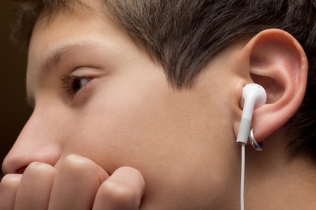Close-up image of a youthful teen wearing earplugs.の写真素材