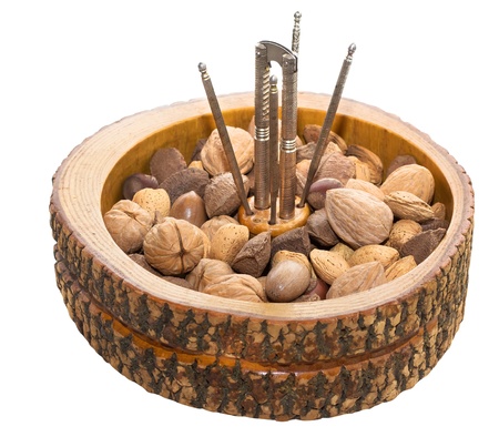 An isolated image of assorted nuts in a rustic wooden bowl.の写真素材