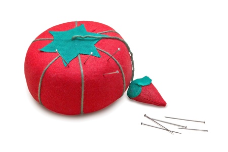 An isolated image of a bright red tomato and strawberry pincushion.の写真素材