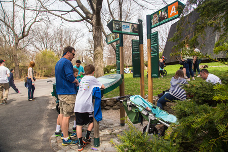 BRONX, NEW YORK - APRIL 14, 2014: View on Bronx Zoo with visitors viewing park map.のeditorial素材