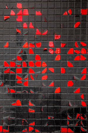 Grungy red and black tile and peeling paint wallの写真素材
