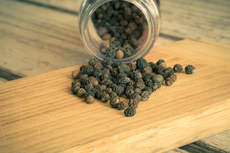 Whole black pepper from a bottle