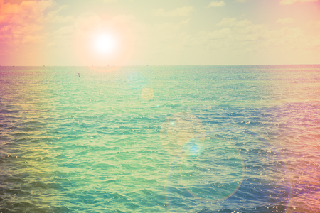 Vintage color photograph style of tropical ocean with sun flareの写真素材