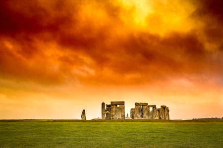 Stonehenge under stormy red orange and yellow sunset sky.の写真素材