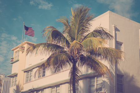 Vintage tone image of palm trees and typical retro art deco style buildings seen from South Beach Miami Floridaの写真素材