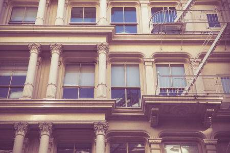 Vintage toned image New York City view of exterior facade on ornate old apartment building residence  seen from lower Manhattanの写真素材