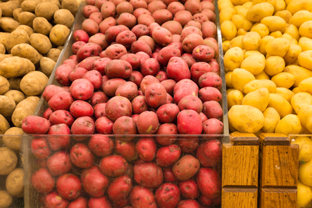 Variety of potatoes in grocery store produce binsの写真素材
