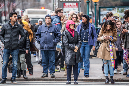 NEW YORK CITY - MARCH 29, 2018: Busy New York City street scene of diversity of pedestrian people crossing the street in Midtown Manhattan on 34th Street Herald Square.のeditorial素材