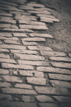 Old New York City cobblestone street repaired with asphalt