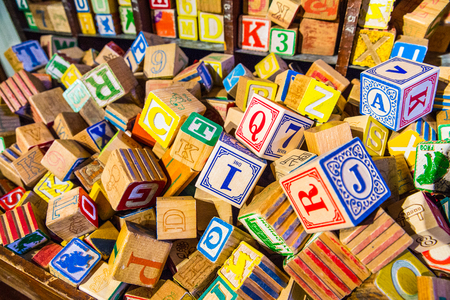 Pile of colorful childrenâs vintage alphabet wooden block toysの写真素材