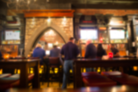 Defocused blur from Irish pub with unrecognizable people at the bar.のeditorial素材