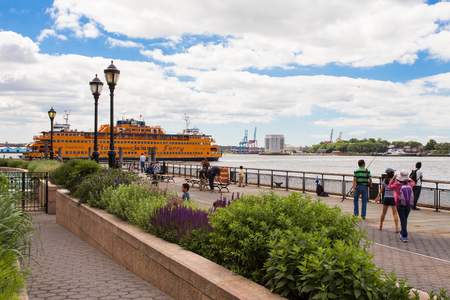 NEW YORK CITY - JUNE 6, 2014:  View from Battery Park in lower Manhattan with the Staten Island Ferry and people in view.のeditorial素材