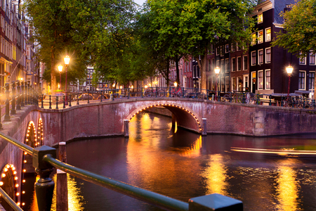Amsterdam evening with bridges, canals and lights at sunsetの写真素材