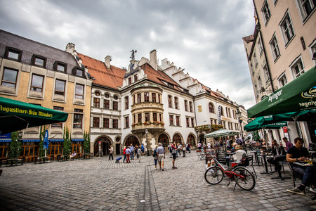 MUNICH, GERMANY - SEPTEMBER 13, 2018:  Street scene outside the historic Haufbrauhaus in Munich Germany with restaurants and people.のeditorial素材