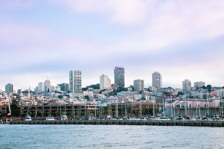 City of San Francisco California seen from the Bay with Bay Bridge, docks and buildings of skyline in view.の写真素材