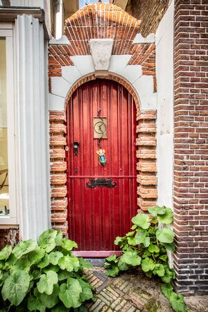Red wood door on lovely european homeの写真素材