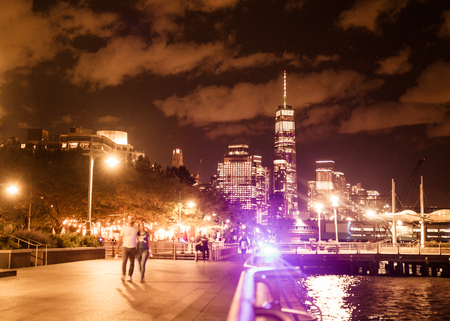 NEW YORK CITY - AUGUST 24, 2019:  View of the skyline of lower Manhattan looking towards the World Trade Center Tower at night with lights seen from dockのeditorial素材