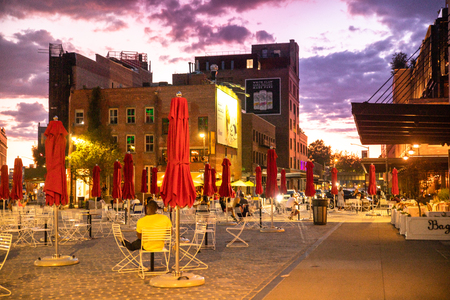 NEW YORK CITY - AUGUST 24, 2019: Sunset at the Gansevoort Plaza with people and outdoor tablesのeditorial素材