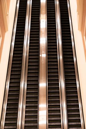 Up and down escalators inside unknown hotel lobby