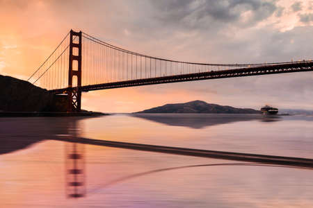 Beautiful Golden Gate Bridge over San Francisco Bay at sunsetの写真素材