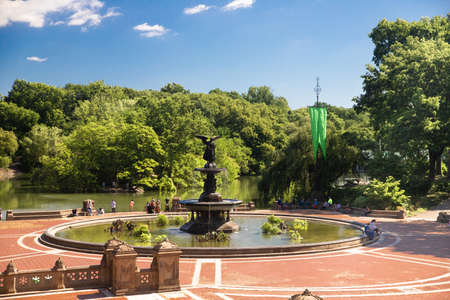 New York - July 11, 2020: View of the historic fountain in New York City, Manhattan on a summer day with unrecognizable people