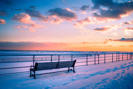 Winter scene under color sky at sunset on snow covered beach. Jones Beach State Park., Long Island NYの写真素材