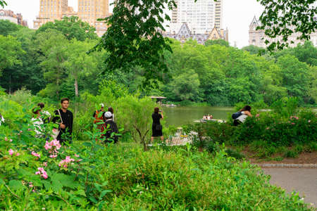 New York City - June 12, 2021:  View of Central Park in Manhattan on a Saturday afternoon with people visiting and relaxing.の写真素材