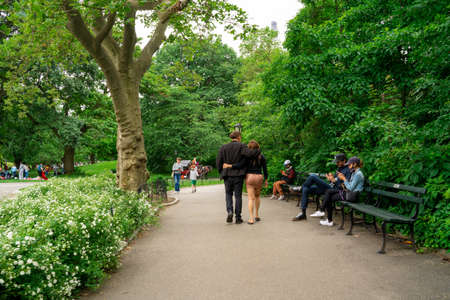 New York City - June 12, 2021:  View of Central Park in Manhattan on a Saturday afternoon with people visiting and relaxing.のeditorial素材