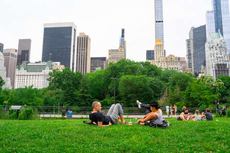 New York City - June 12, 2021:  View of Central Park in Manhattan on a Saturday afternoon with people visiting and relaxing.のeditorial素材