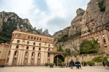 Montserrat, Spain - April 20, 2022:  View of Monserrat Monastery in the Mountains of Catalonia seen with visitors.のeditorial素材