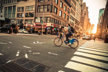 New York City, New York - June 14, 2018:  View of busy midtown Manhattan Street with vehicles at sunset photographed on Broadway.の写真素材