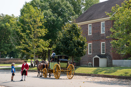 Williamsburg, Virginia, USA - September 12, 2021:  Street scene with horse drawn carriage along the street in historic Colonial Williamsburg VA.のeditorial素材