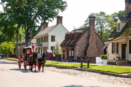 Williamsburg, Virginia, USA - September 12, 2021:  Street scene with horse drawn carriage along the street in historic Colonial Williamsburg VA.のeditorial素材