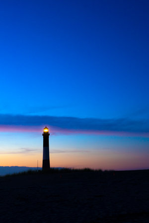 Beautiful view of historic Fire Island Lighthouse along Fire Island National Seashore on Long Island New York seen at evening sunset.の写真素材