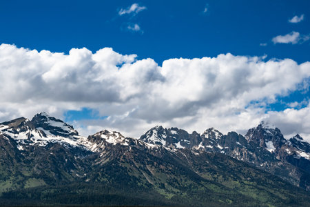 Yellow highway dividing lines with beautiful landscape from Grand Teton National Parkの写真素材
