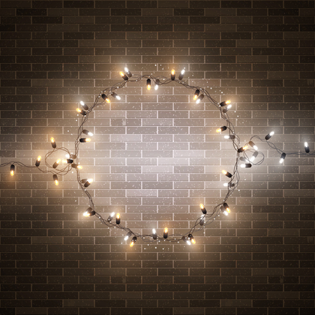 Christmas decorative realistic garland with shiny  glowing lights, round frame on brick wall background, vector illustrationのイラスト素材