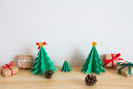 Paper christmas tree with presents and pinesの写真素材