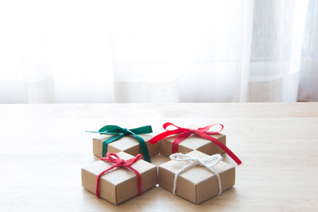 4 presents on wood table, christmas giftsの写真素材