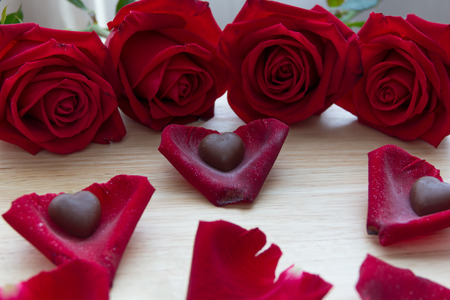 red roses with chocolate in petalsの写真素材
