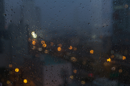 water drop on window with bokeh at night roadの写真素材