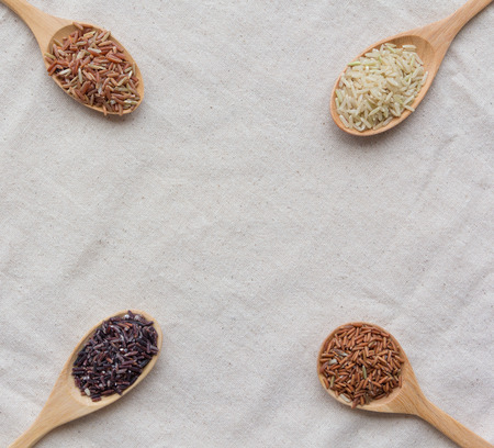 many type of brown rice on wood spoonの写真素材